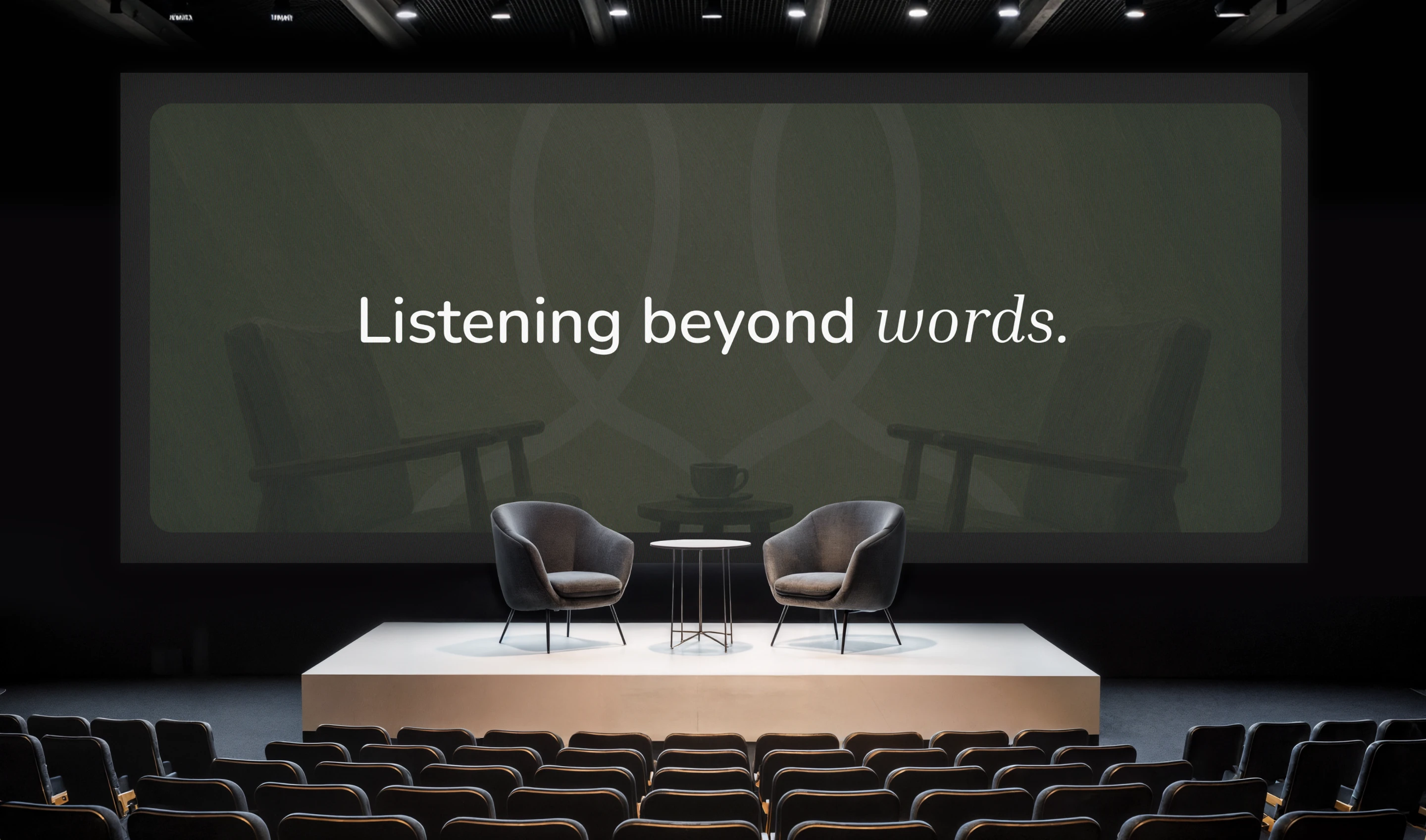 An auditorium with Listening beyond words on the screen
