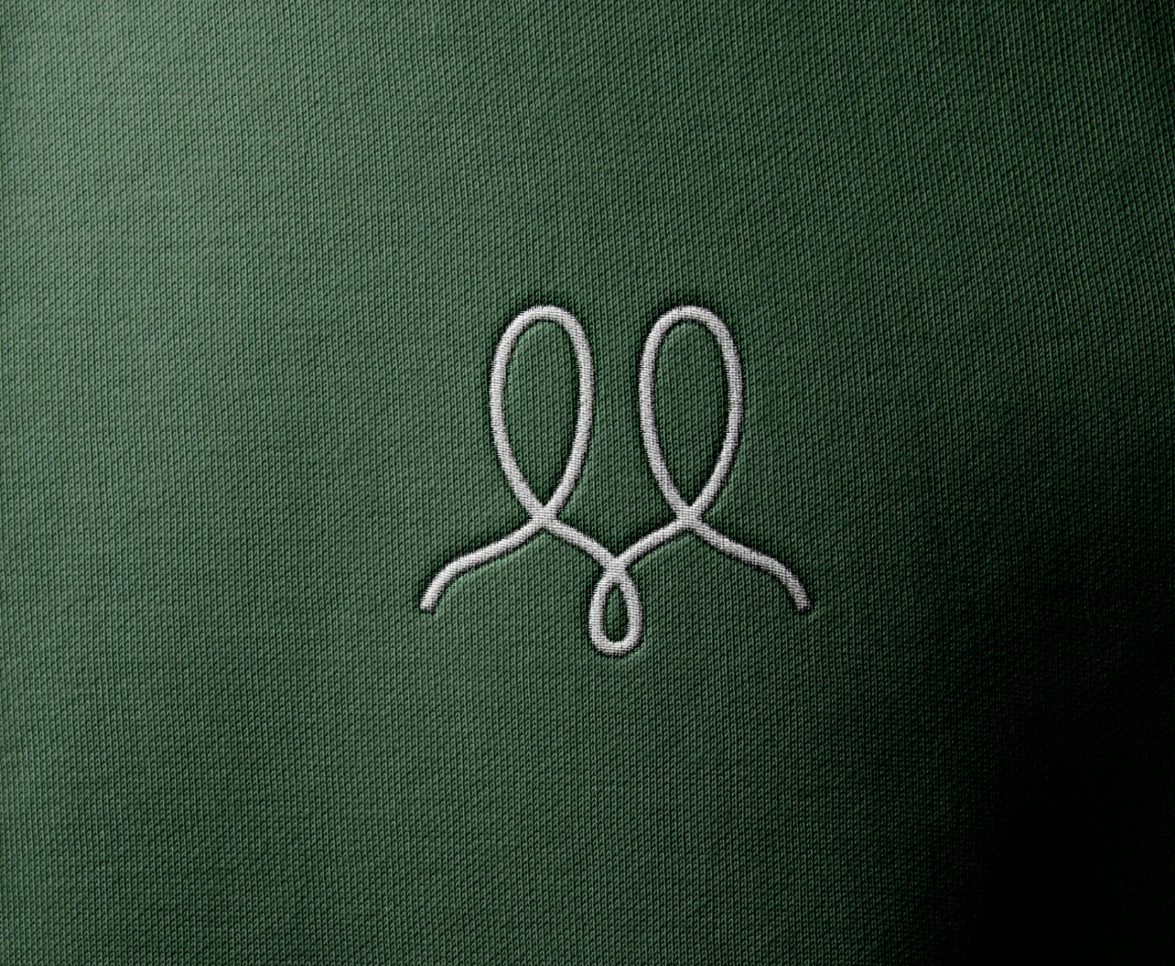 UAPP mark embroidered on green fabric