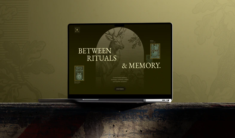 A laptop showing the Algiz homepage: 'Between rituals & memory' over an arch framing a stag